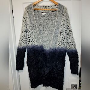 Long mid knee faded black to gray sweater with pockets.